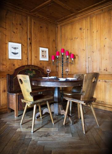 a wooden dining room with a table and chairs at Flyhof in Weesen