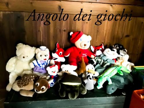 a group of stuffed animals sitting on a shelf at Chèvres à Cheval - Apartment in Aosta