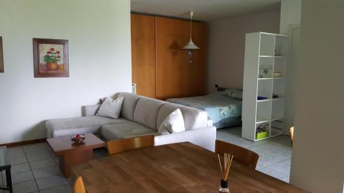 a living room with a couch and a table at Poggio San Fermo in Omegna