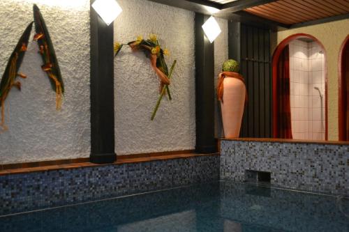 a bathroom with two mannequins on the wall at Hotel Brandl in Bad Wörishofen