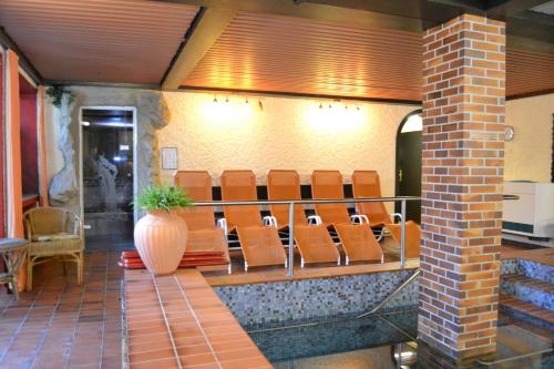 a row of chairs sitting in a waiting room at Hotel Brandl in Bad Wörishofen