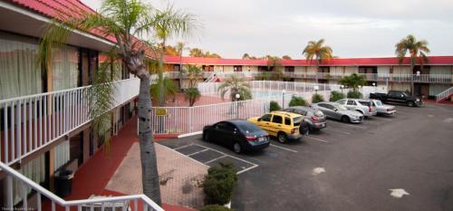 a group of cars parked in a parking lot in front of a motel at Express Inn & Suites - 5 Miles from St Petersburg Clearwater Airport in Clearwater