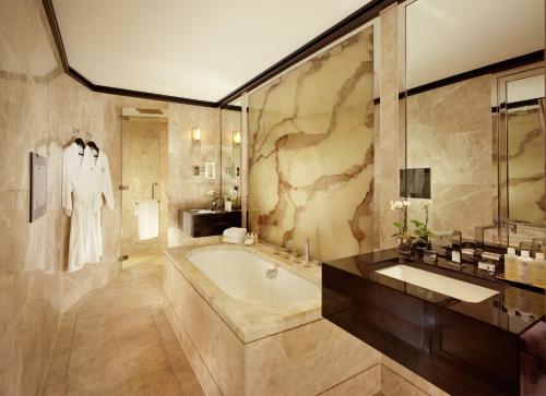 a bathroom with a tub and a sink at 45 Park Lane - Dorchester Collection in London