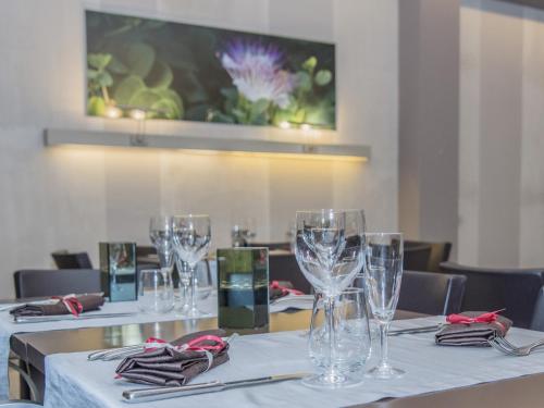 a row of tables with wine glasses on them at Hotel La Bussola in Milazzo