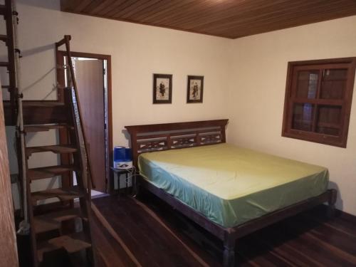 a bedroom with a bed and a ladder in it at O Refúgio Colonial in Nova Friburgo