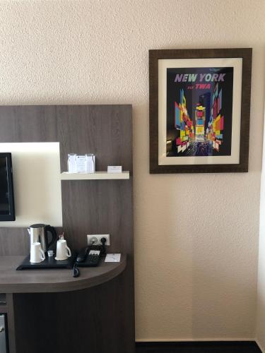 a picture hanging on a wall in a hotel room at Best Western Marseille Aeroport in Vitrolles