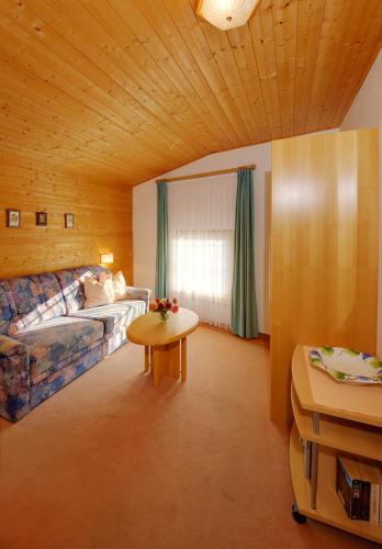 a living room with a couch and a table at Unterdornerhof in Lagundo