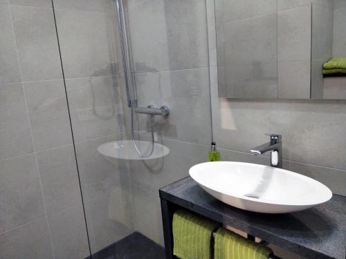 a bathroom with a sink and a shower at Hotel Nachtquartier in Weil der Stadt