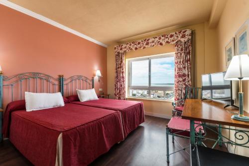 Katil atau katil-katil dalam bilik di Hotel Guadalquivir
