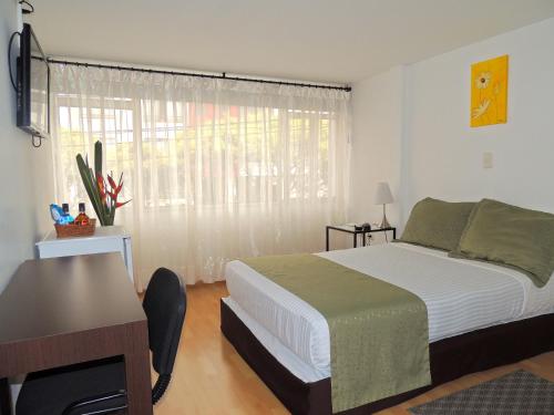 מיטה או מיטות בחדר ב-Hotel Portal de Milán