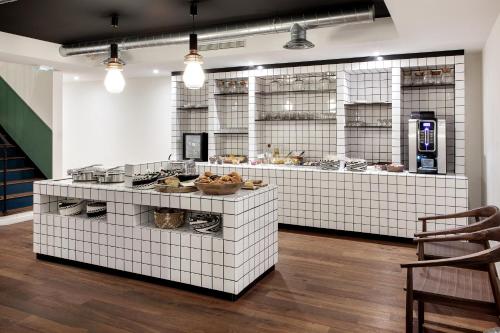 a kitchen with a counter with food on it at New Hotel Le Voltaire in Paris