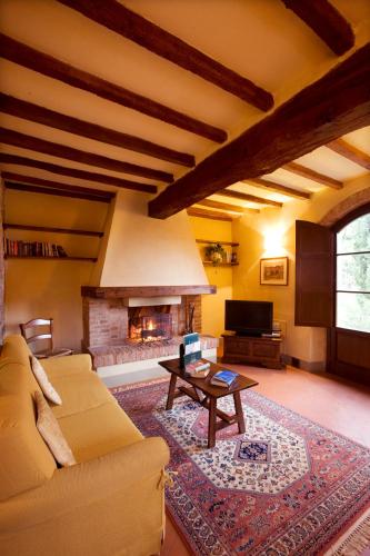 a living room with a couch and a fireplace at Monsignor Della Casa Country Resort & Spa in Borgo San Lorenzo