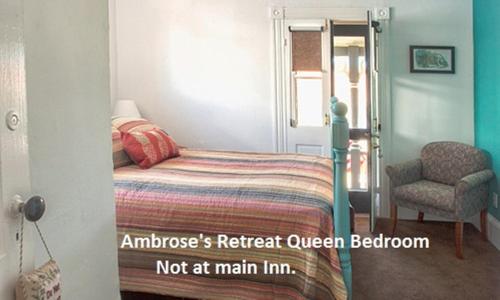 a bedroom with a bed and a chair in it at St. Francis Inn - Saint Augustine in Saint Augustine