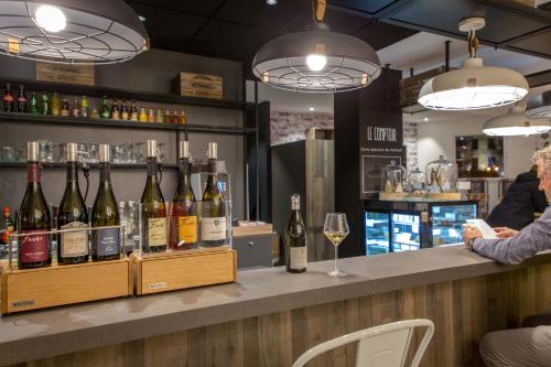 a bar with a bunch of bottles of wine at ibis Lyon Sud Vienne Saint-Louis in Vienne
