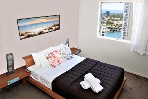 a bedroom with a large bed and a window at Trilogy Surfers Paradise in Gold Coast