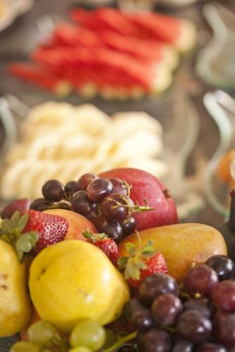a pile of fruit sitting on top of a table at Bourbon Residence Barra da Tijuca - Rio de Janeiro in Rio de Janeiro