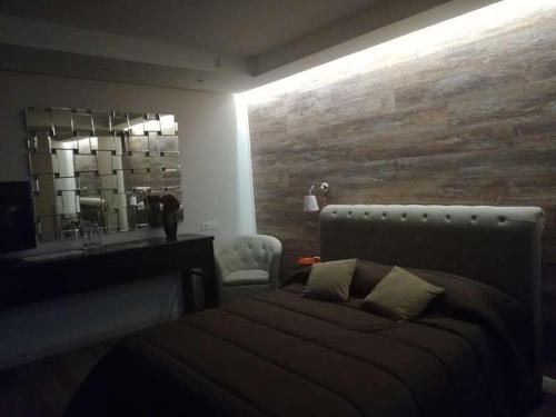 a bedroom with a large bed and a mirror at Tenuta Terra e Sole in Castrocielo