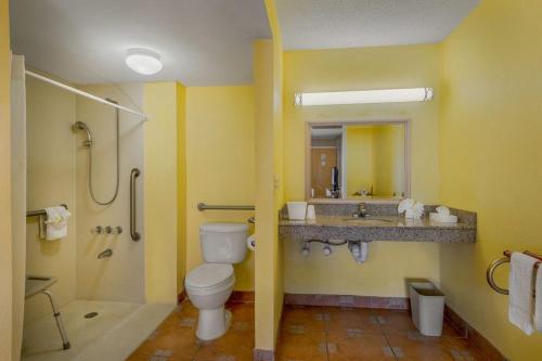 a bathroom with a toilet and a shower and a sink at Express Inn & Suites - 5 Miles from St Petersburg Clearwater Airport in Clearwater