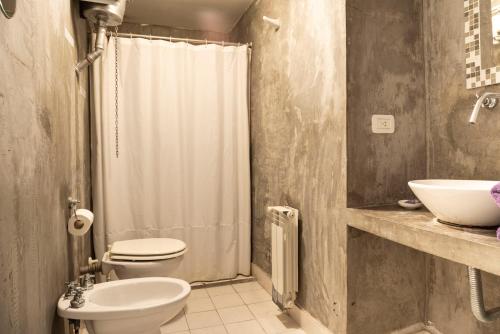 a bathroom with a toilet and a sink and a shower at ChillHouse in Buenos Aires