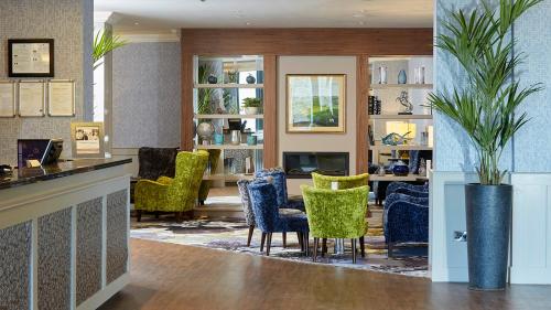a lobby with chairs and a table and a bar at Tower Hotel & Leisure Centre in Waterford