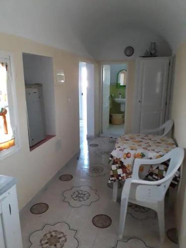 a room with a table and a chair in it at Beltaief Residence in Houmt Souk
