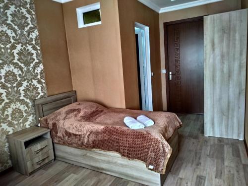 a bedroom with a bed with two towels on it at My House in Akhaltsikhe in Akhaltsikhe
