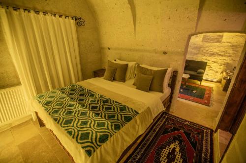 a bedroom with a bed and a mirror at Wish Cappadocia in Uchisar