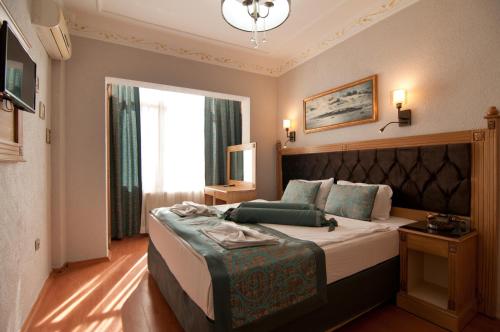 a hotel room with a large bed and a large window at Blue Tuana Hotel in Istanbul