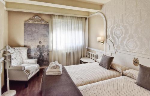 Postel nebo postele na pokoji v ubytování Hotel Maria Luisa