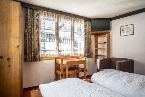 Postel nebo postele na pokoji v ubytování Hotel Burgener