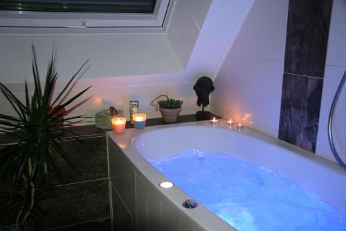 a bathroom with a large tub with candles in it at Ferienwohnung Dieter Popp in Münchberg