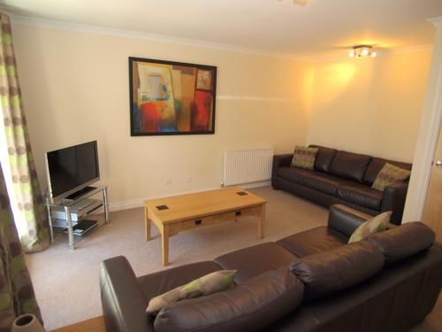 a living room with a couch and a coffee table at Allanfield Townhouse in Edinburgh