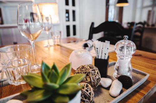a wooden table with glasses and bottles and rocks on it at Hotel Burgener in Saas-Fee