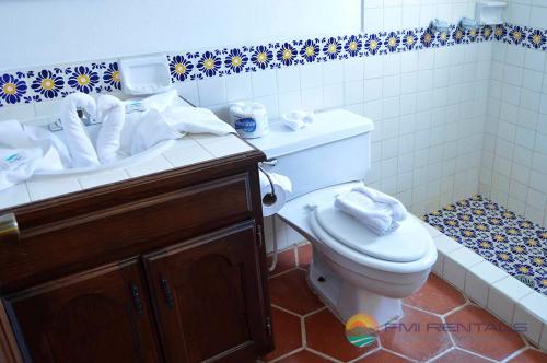a bathroom with a toilet and a sink at Casita Blanca by FMI Rentals in Puerto Peñasco