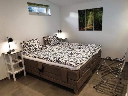 a bedroom with a large bed and a night stand at PAX Apartments in Lund