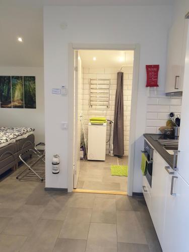 a kitchen with a door open to a kitchen with a counter at PAX Apartments in Lund