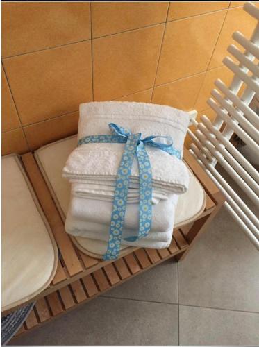 a pile of towels and towels on a shelf at B&B Beauty House in Cesena
