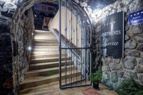 a set of stairs in a stone building with a sign at Apartments Lucia Senj in Senj