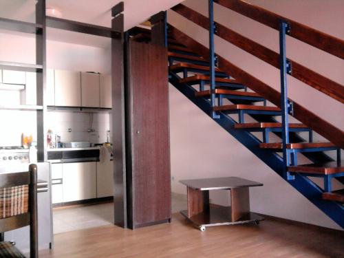 a kitchen with a staircase and a table in a room at Sunset Zaglav Apartment in Martinšćica