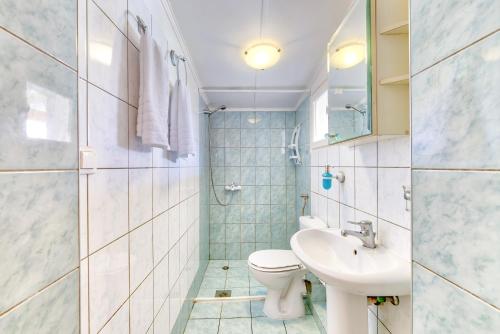 a bathroom with a toilet and a sink at Ina Apartment in Kalamaki