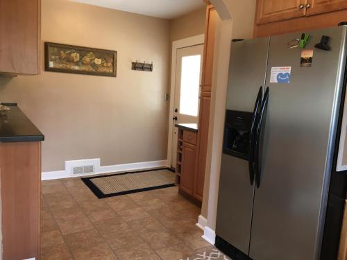 a kitchen with a stainless steel refrigerator and a doorway at Grafton Lodge in Lake Lure