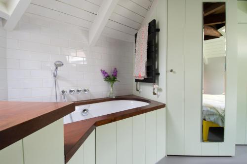 a bathroom with a white sink and a counter at Unique 3 floor apartment at Westerpark in Amsterdam