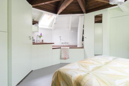 1 dormitorio con 1 cama en una habitación blanca en Unique 3 floor apartment at Westerpark, en Ámsterdam