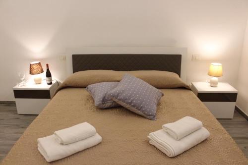 a bedroom with a large bed with two pillows at Case Vacanze Mare Blu in Castellammare del Golfo