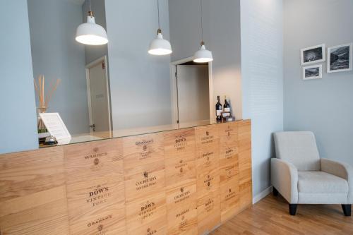 a dressing room with a mirror and a chair at Decanting Porto House in Porto