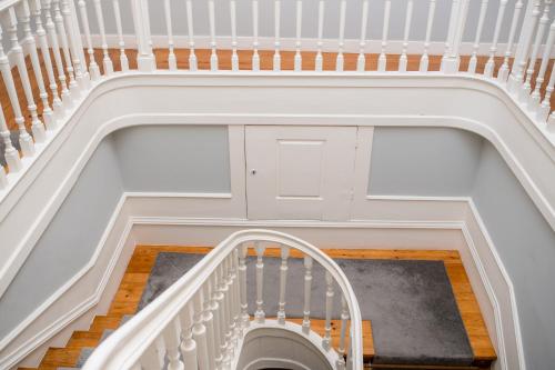 an overhead view of a stairway with a white stair case at Decanting Porto House in Porto