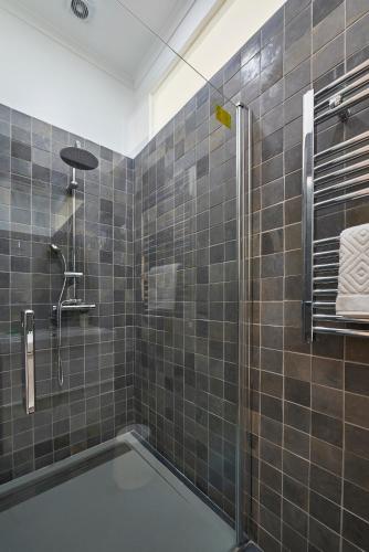 a bathroom with a shower with a glass door at Rua dos Remédios 179 in Lisbon