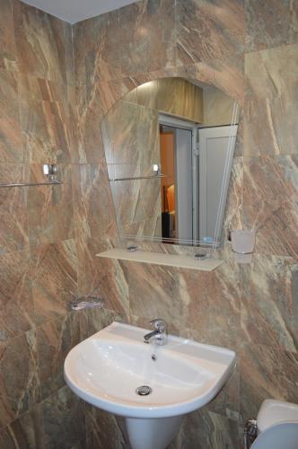 a bathroom with a sink and a mirror at Yanis in Chernomorets