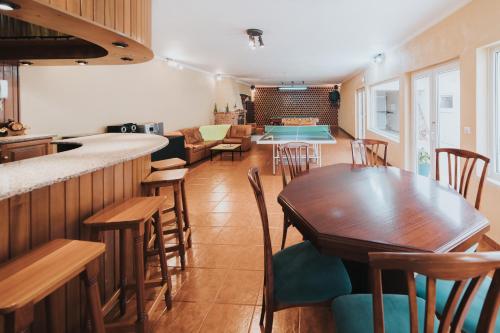 a kitchen and dining room with a table and chairs at 10 min from the beach Game room with fireplace Pool in Seixo