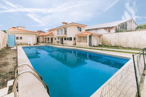 a swimming pool in front of a house at 10 min from the beach Game room with fireplace Pool in Seixo